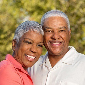 Senior man and woman smiling together outdoors