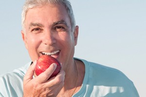 man enjoying the benefits of implant dentures in Carrollton
