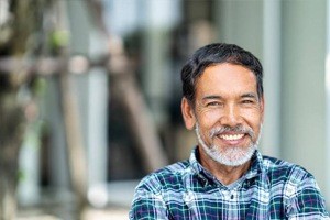 Older man smiling outdoors