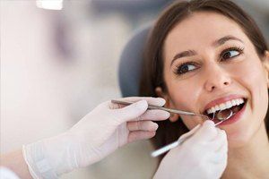 Woman having teeth cleaned at the dentist