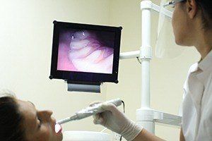 Dentist and patient looking at intraoral photos