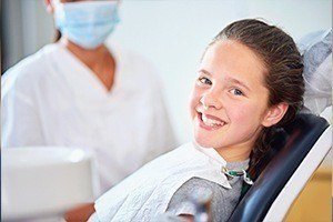 Smiling girl in dental chair