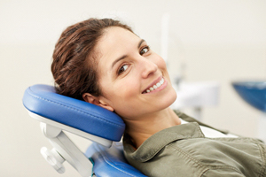 A woman smiling while in the dentist’s chair