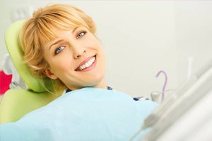 Smiling patient in dentist chair