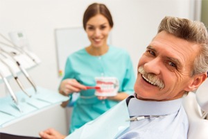An older man smiling in the dentist chair