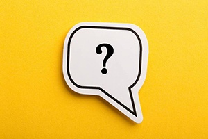 Question mark in speech bubble for dental implant FAQs in Carrollton 