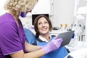 Carrollton implant dentist speaking with patient about dental implants