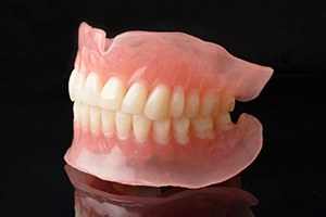 a pair of dentures against a black background