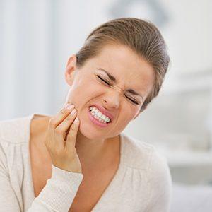 Pained woman in need of a Carrollton emergency dentist