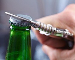closeup of bottle opener to prevent dental emergencies in Carrollton