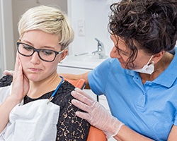 Pained woman visiting her dentist for a toothache in Carrollton