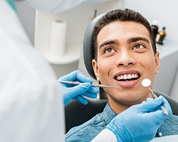 Man smiles during dental checkups and cleanings in Carrollton