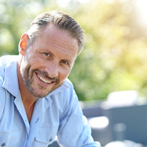 man smiling with implant dentures in Carrollton