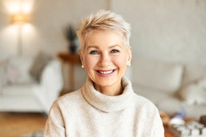 woman smiling with removeable implant dentures in Carrollton