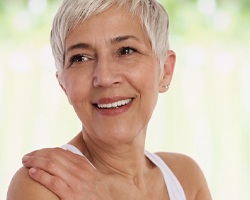 Woman smiling with dental implants in Carrollton