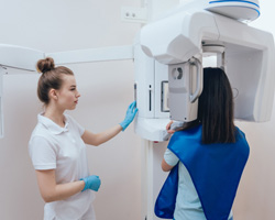 A dentist taking images with a cone beam scanner