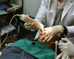 A dentist using a digital impression system on a patient