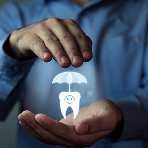 Man’s hand holding animated tooth and umbrella