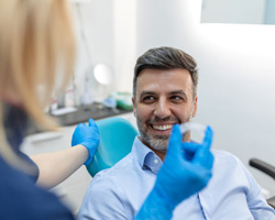 Dentist discussing Invisalign with a male patient 