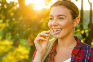 Young female wearing Invisalign outdoors