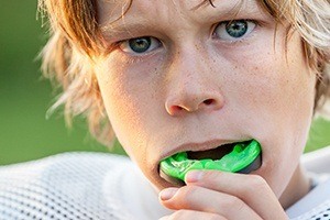 Teen boy placing sports mouthguards