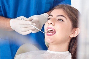 Woman receiving oral cancer screening