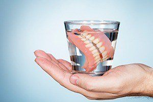 Full denture in glass of water