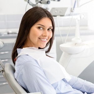 Female patient smiling after root canal therapy in Carrollton, TX