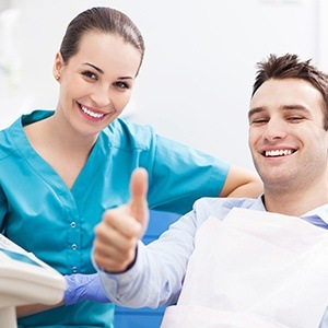 Man in dental chair giving thumbs up