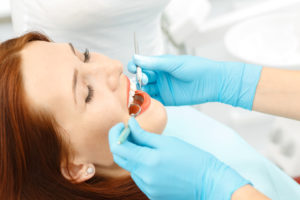 Relaxed woman receiving dental treatment