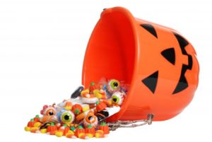 A Jack-o-Lantern bucket spilling candy.