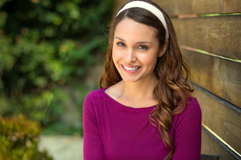 a young woman outside smiling