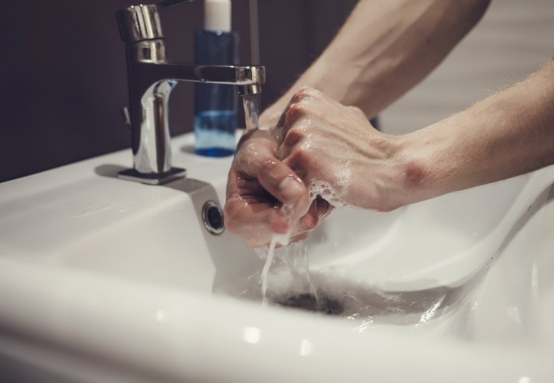 Close-up of dental team member washing their hands