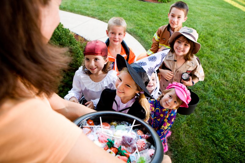 Group of kids smiling while trick-or-treating