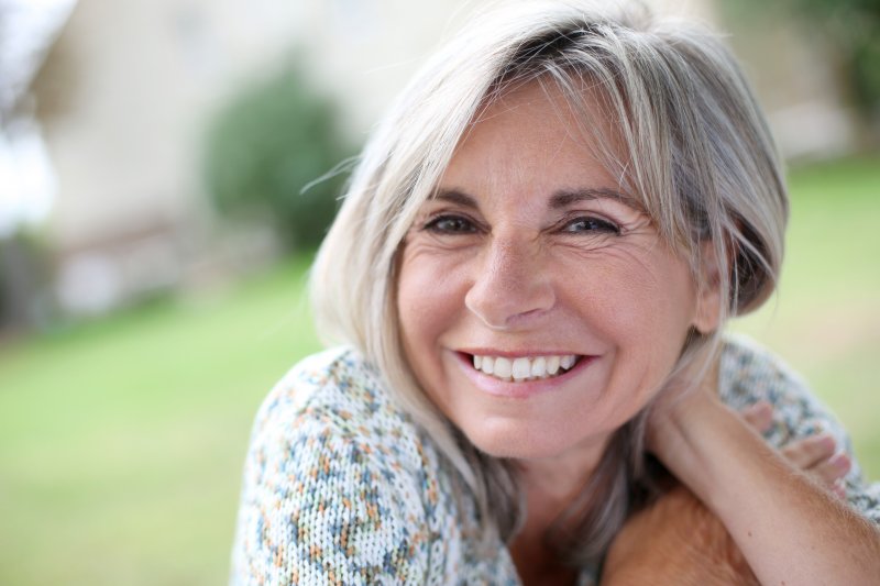 Portrait of smiling serene senior woman in a garden