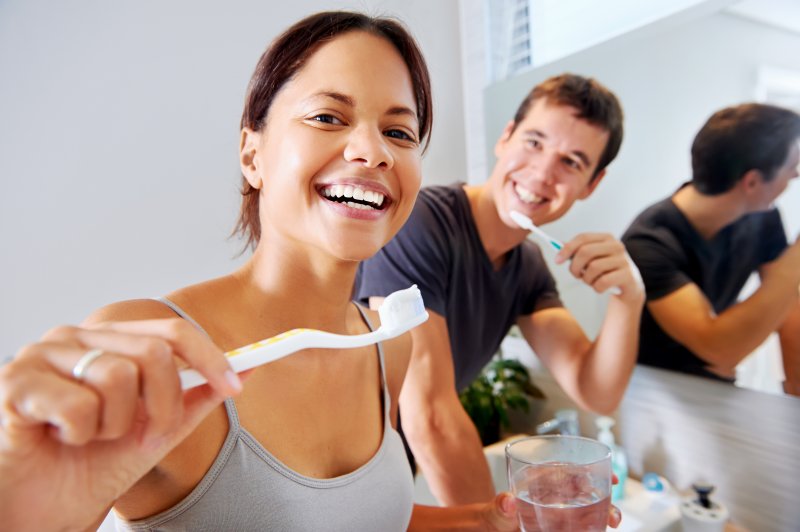 couple brushing their teeth