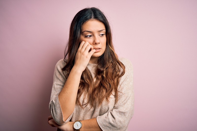 A woman upset by her poor oral health